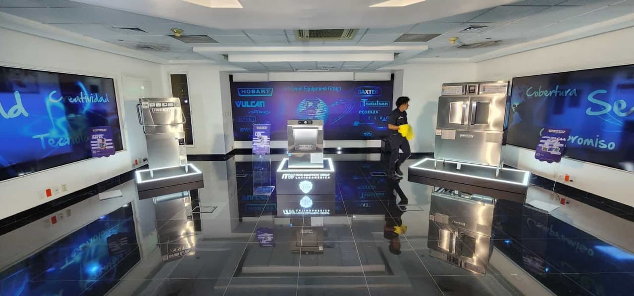 Showroom con tarimas de exhibición iluminadas en su perímetro y muros gráficos